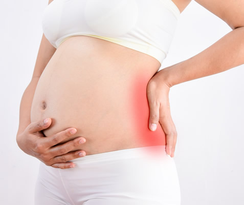 Expecting mother receiving a prenatal massage at our Houston clinic